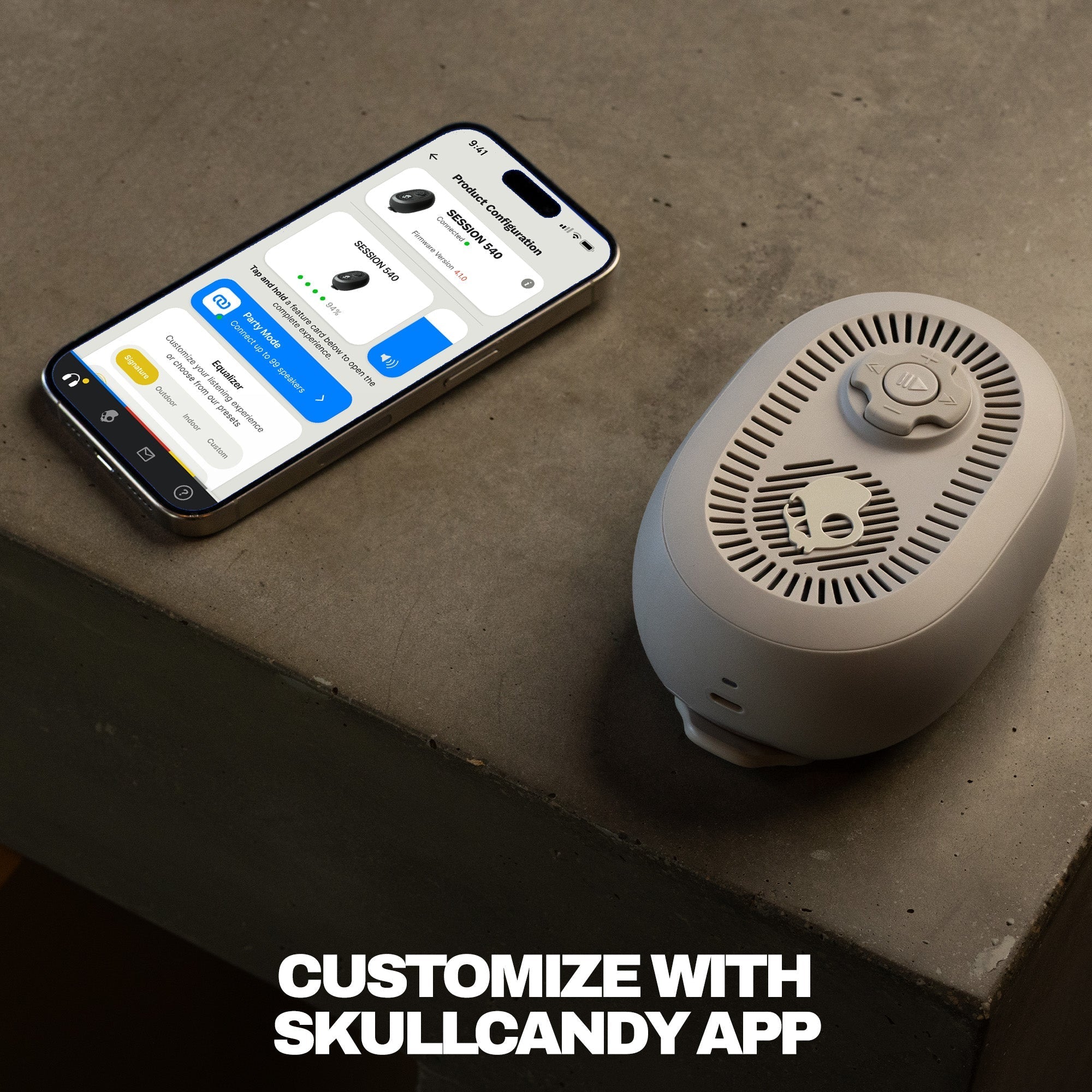 Smart speaker on a concrete surface with a smartphone displaying an app interface, text 'Customize with Skullcandy App'. | Cement