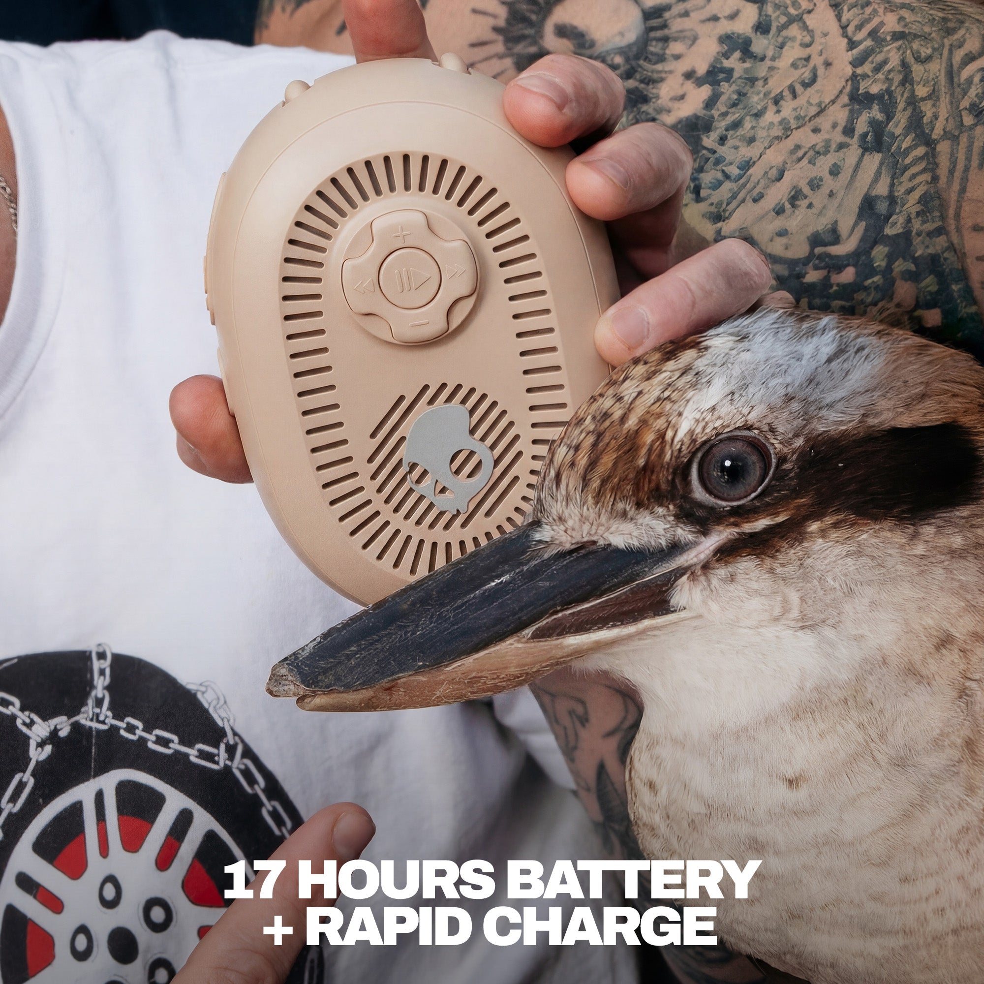 Person holding a beige portable speaker next to a bird, with text about battery life and charging. | Primer