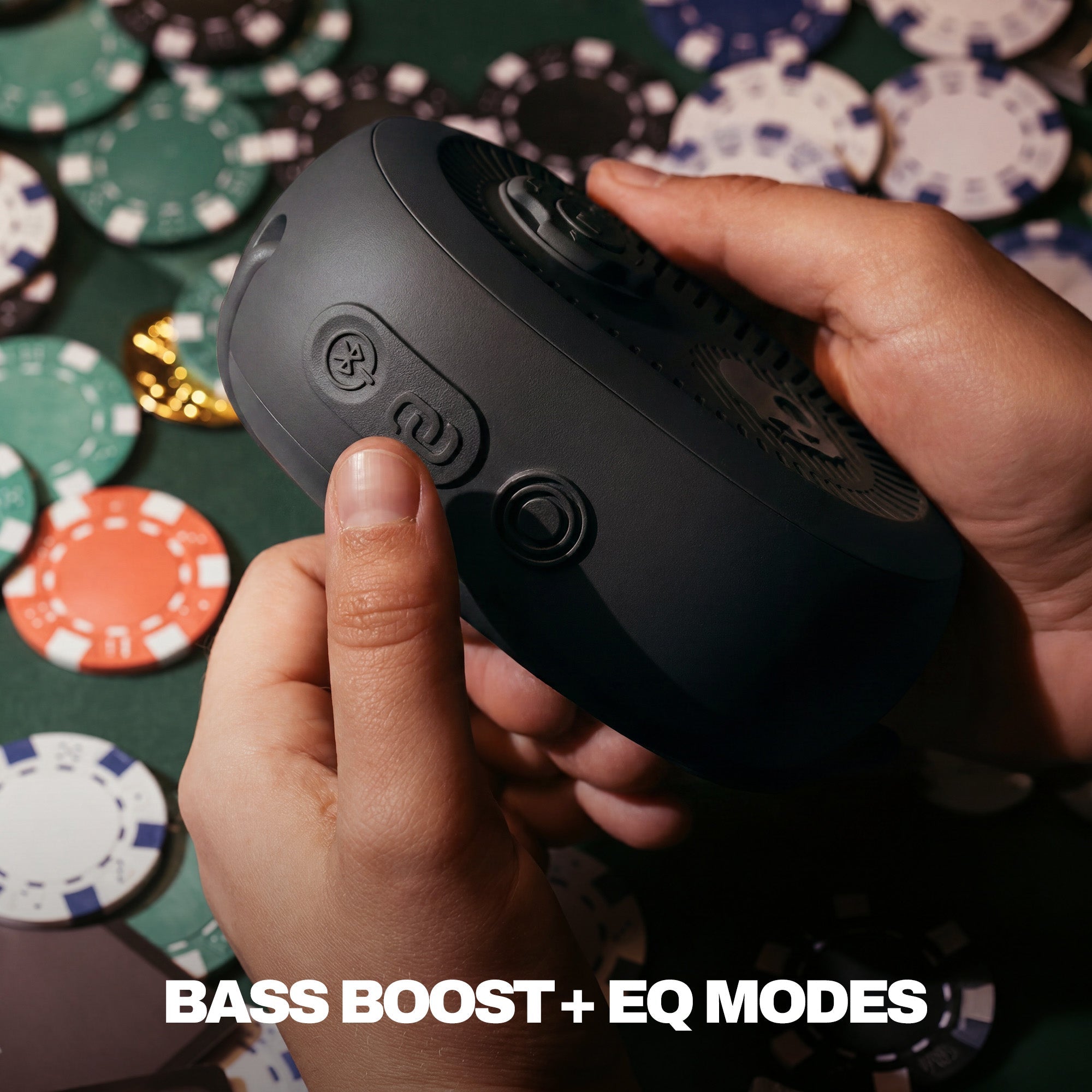 Person holding a black speaker with poker chips in the background | True Black