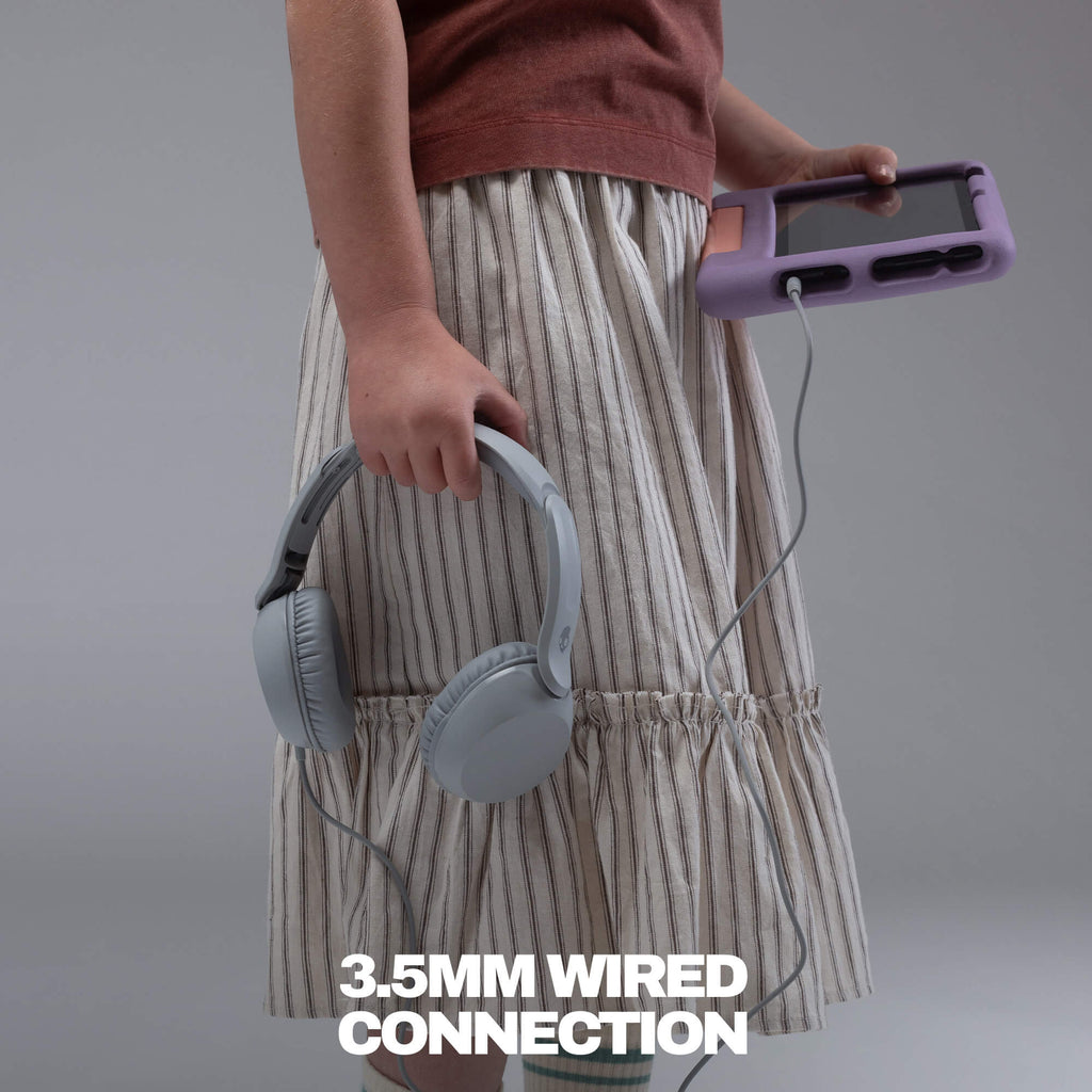 A person wearing a beige and white striped skirt holds a pair of light gray over-ear headphones and a purple portable music player connected by a 3.5mm wired cable, with white text at the bottom reading '3. | Cement