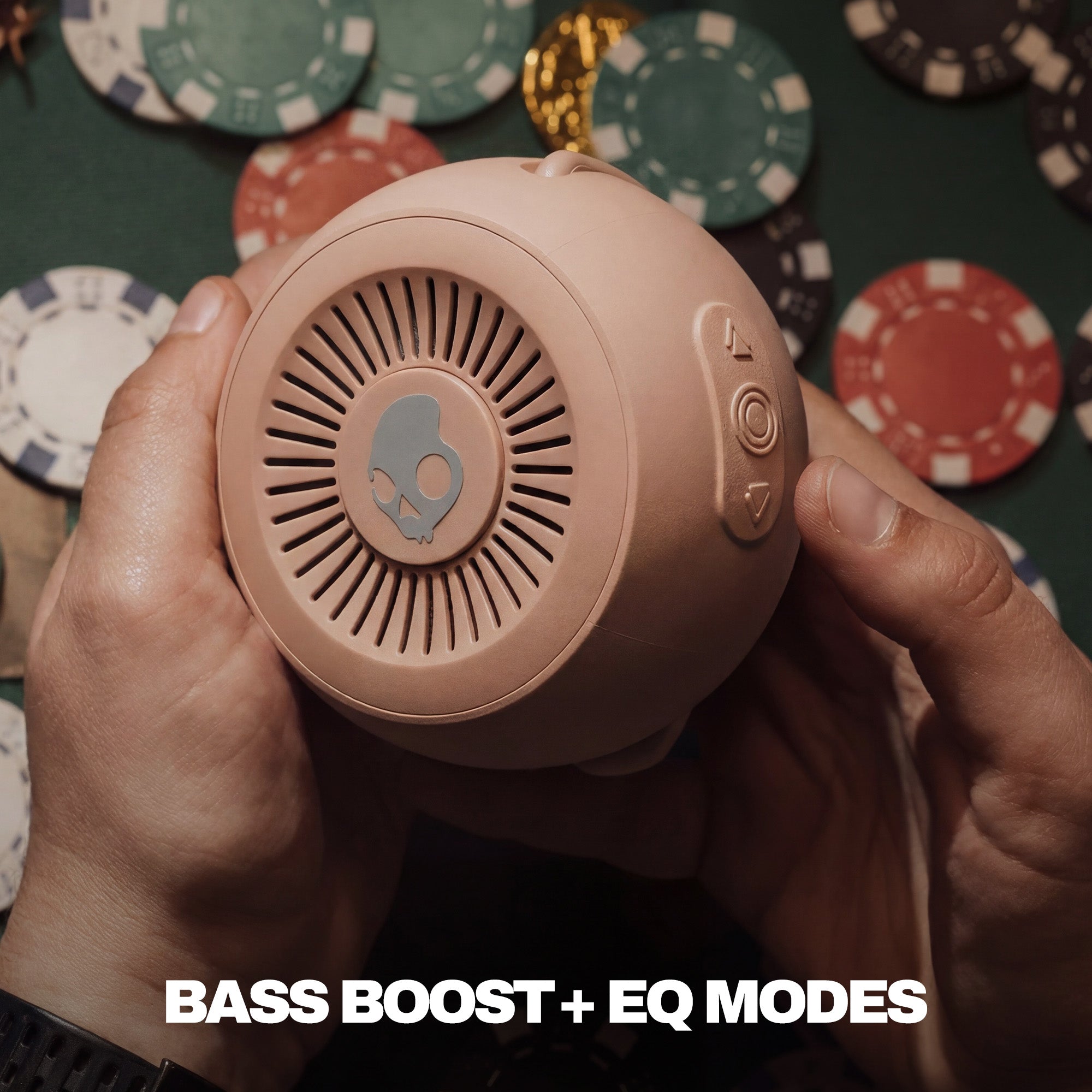 Person holding a brownish speaker with poker chips in the background | Primer