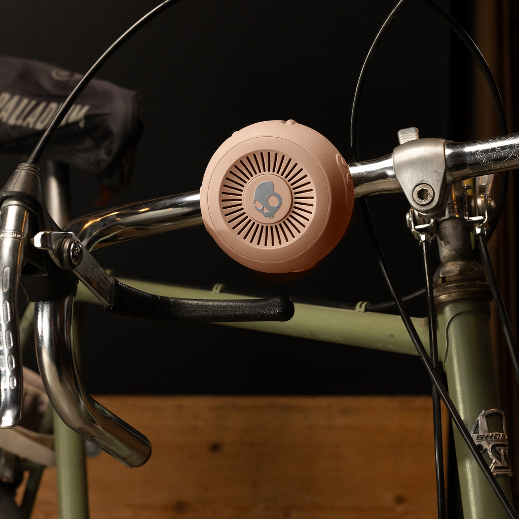 speaker attached to a bike handlebar with a dark background | Primer