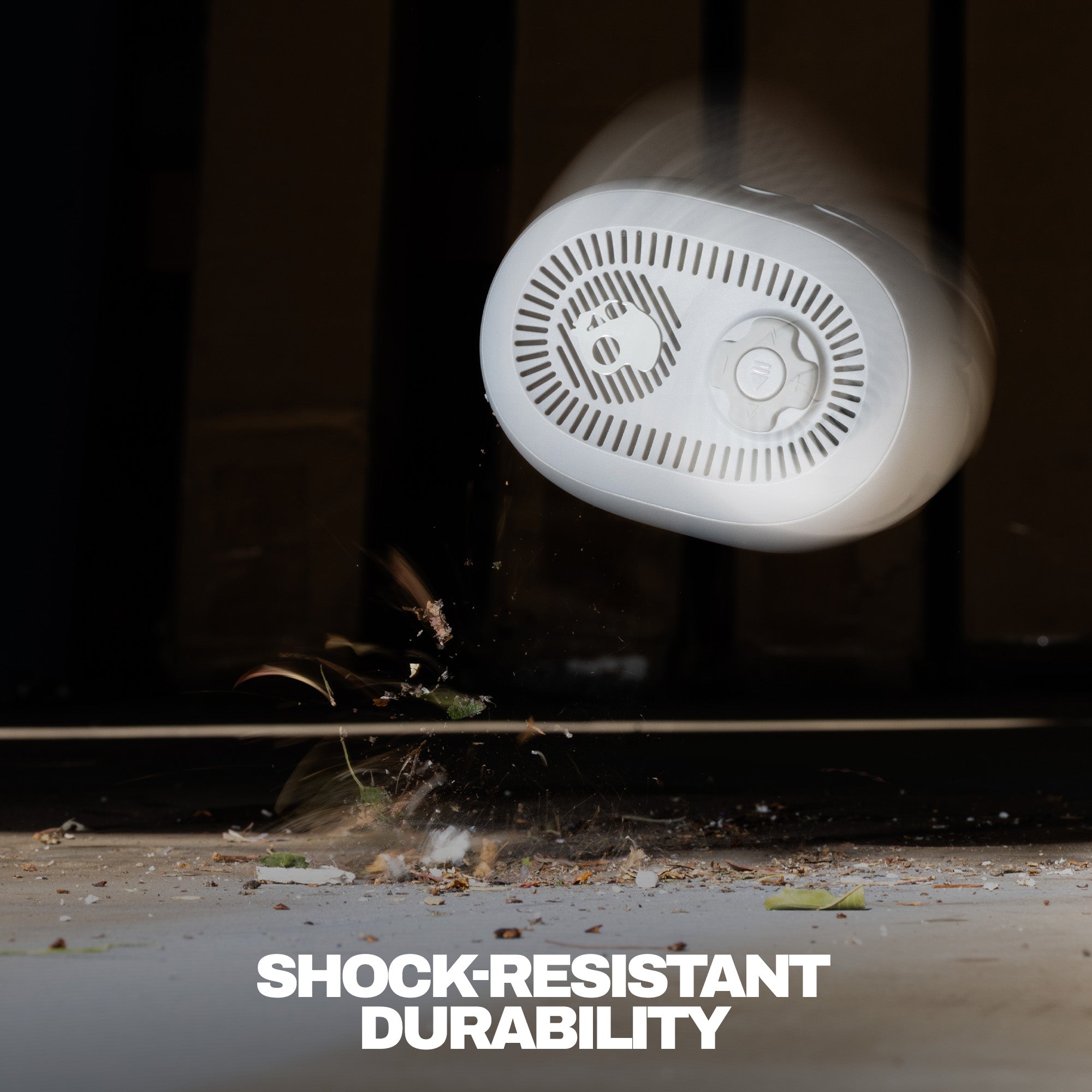 Close-up of a speaker with text 'Shock-Resistant Durability' on a dark background | Cement