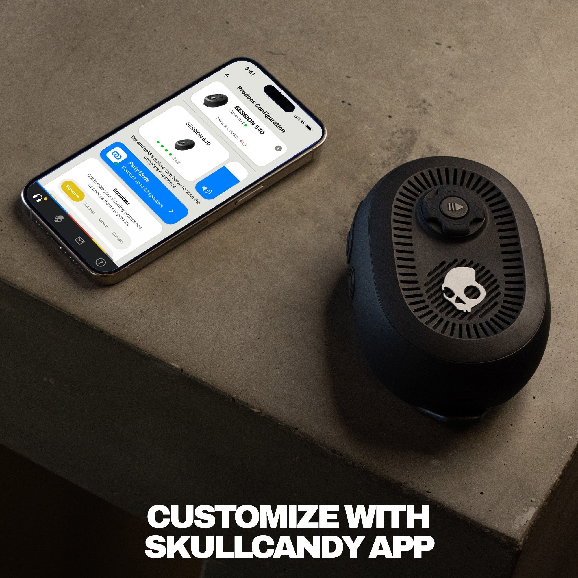 Black skull-shaped speaker next to a smartphone on a concrete surface with 'Customize with Skullcandy App' text. | True Black