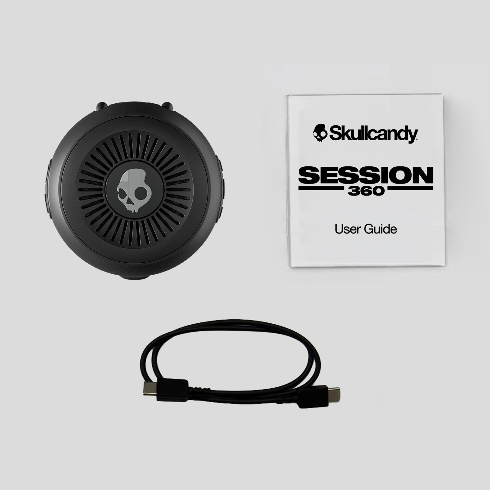Skullcandy Session 360 headset with user guide on a light gray background | Cement