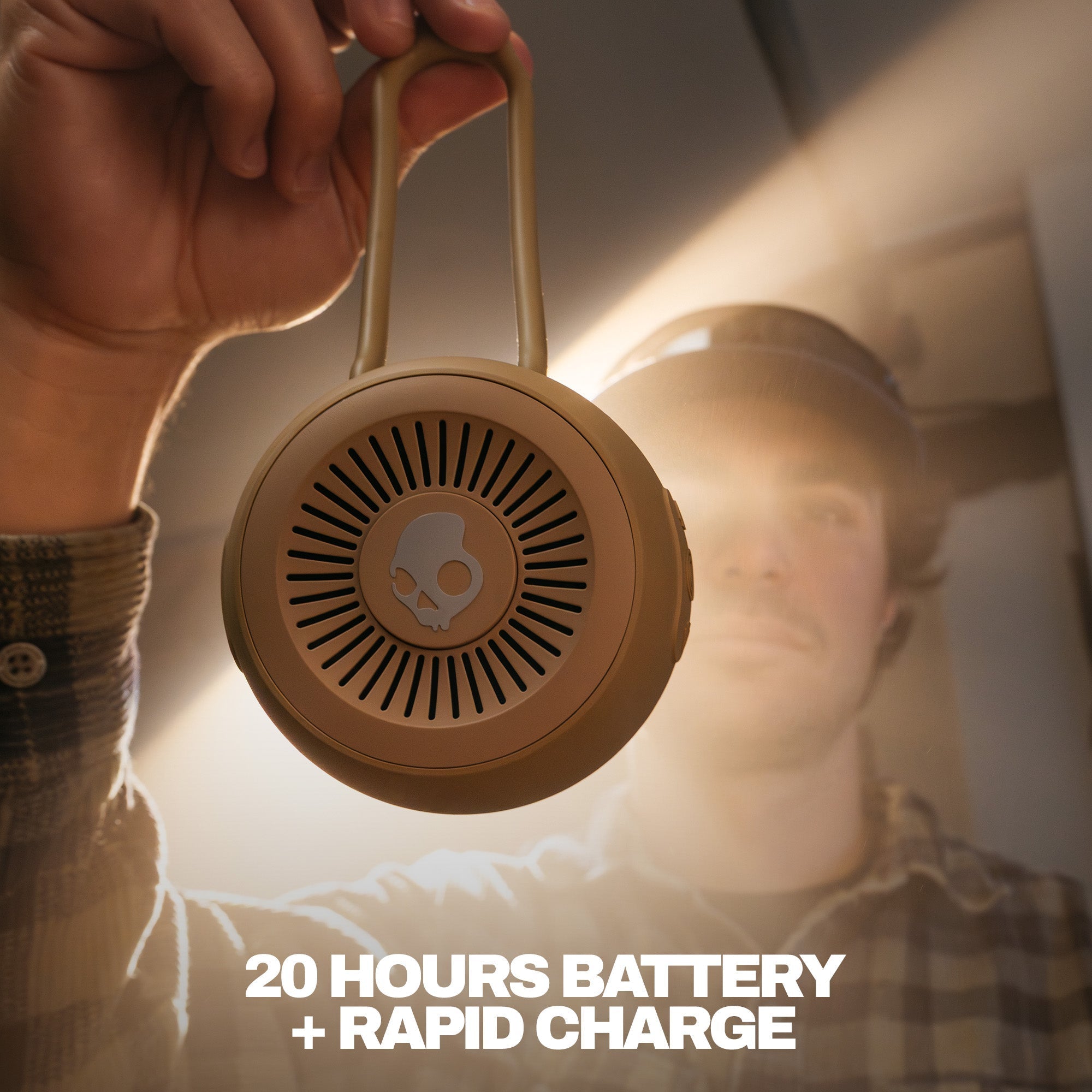 Beige portable speaker held by a hand with text about battery life and charging speed. | Primer