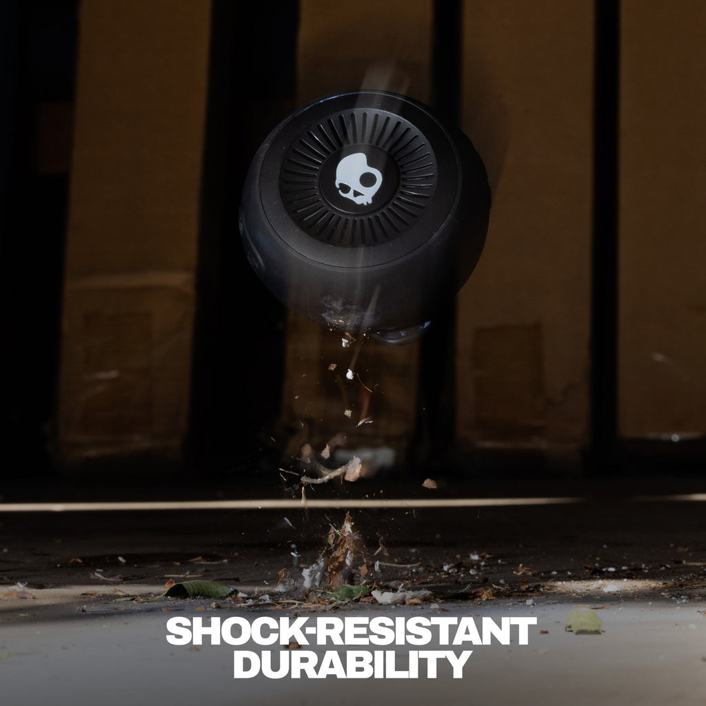 Black speaker being dropped onto a concrete surface with 'Shock Resistant Durability' text. | True Black