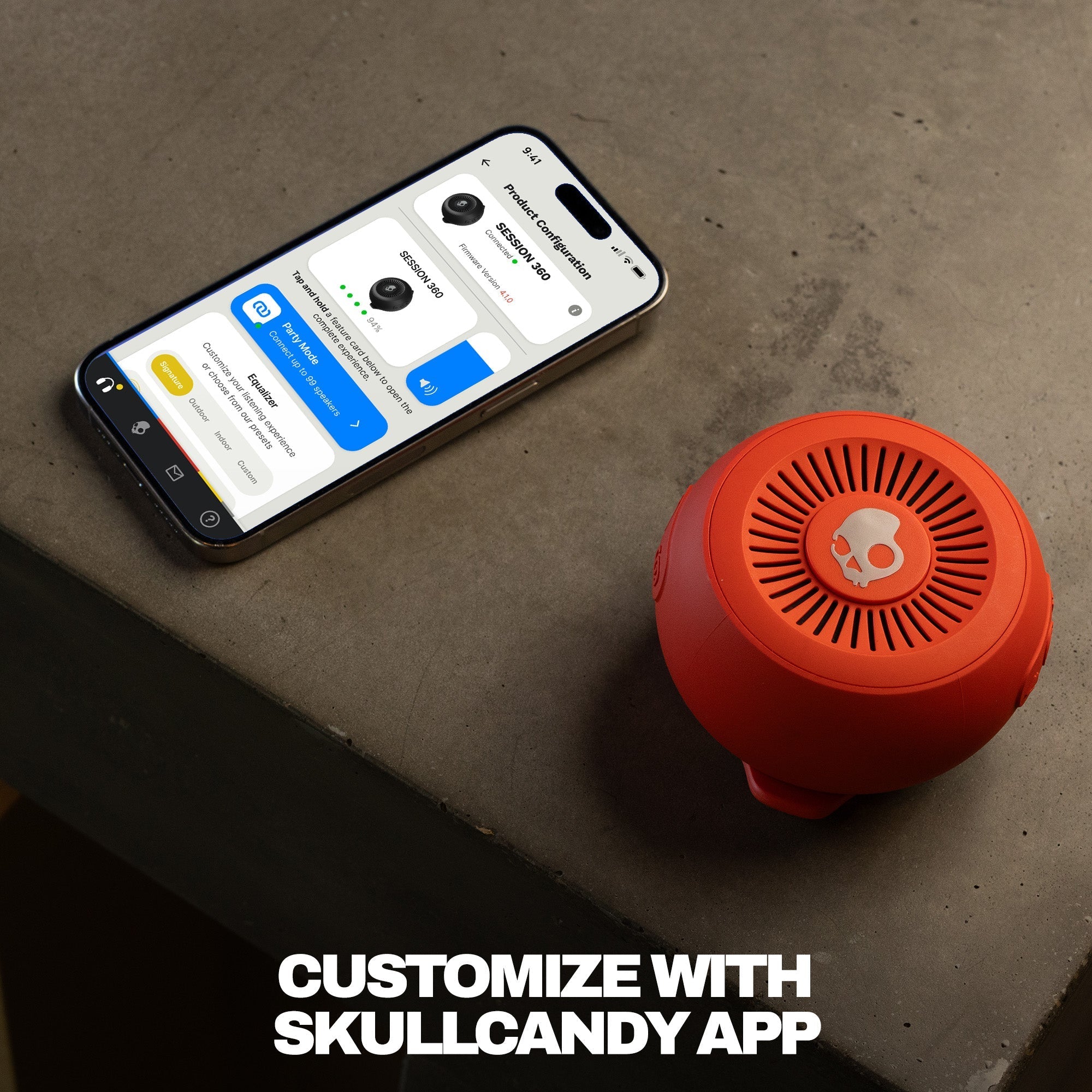 Red Bluetooth speaker next to a smartphone displaying the Skullcandy app on a concrete surface. | Plasma