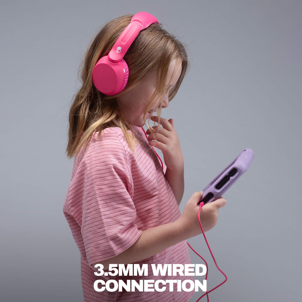 A young girl with blonde hair wearing a pink striped shirt and bright pink on-ear headphones is shown from the side, holding a purple wired device with a red cable. The image has a gray studio background and white text at the bottom that reads '3. | Crazy Pink
